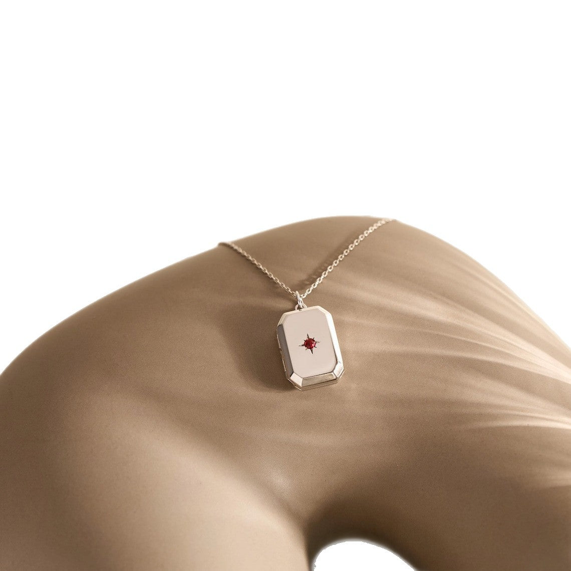 A Pendant Necklace With Birthstones Embedded In It