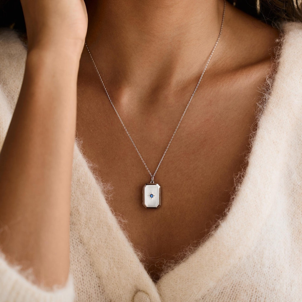 A Pendant Necklace With Birthstones Embedded In It